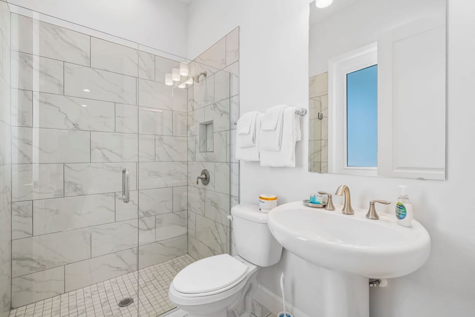A clean, modern shower space allows guests to freshen up with ease and comfort after a day under the Florida sun.