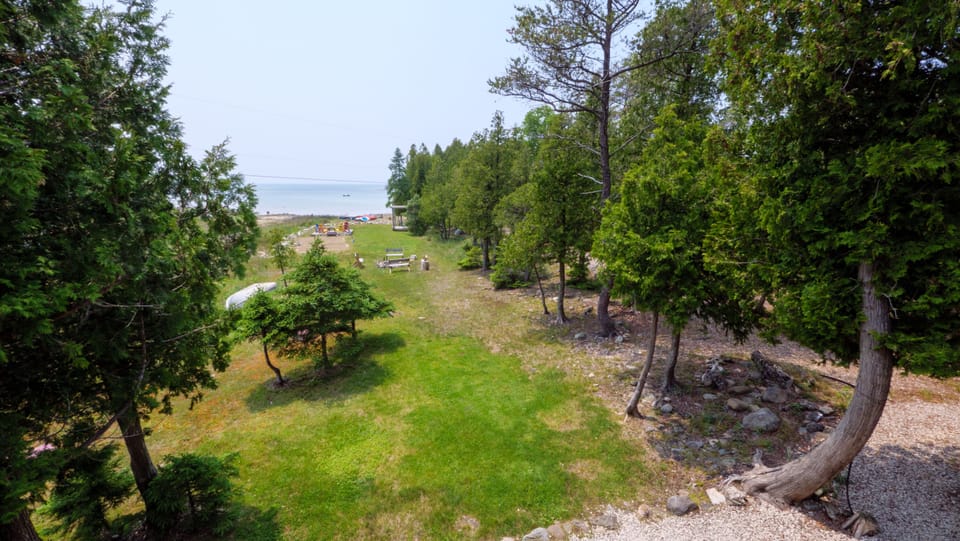 The expansive and neatly landscaped yard has plenty of space for fun and games.