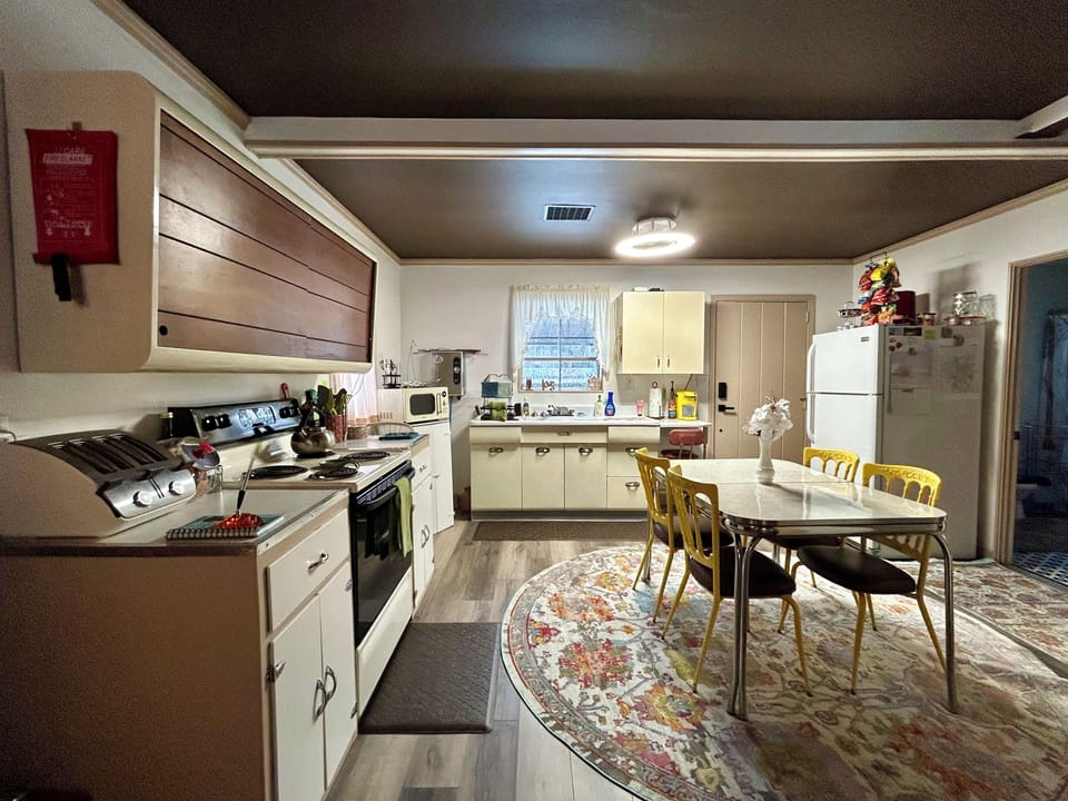 View of kitchen from living room. Closed door on the right goes out to fire pit.