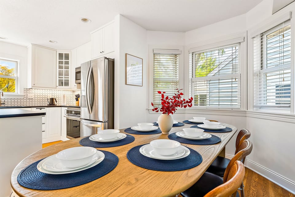 The oval dining table comfortably seats up to 10 guests, with chairs that can also enhance the welcoming atmosphere of the living room. "This Home was absolutely amazing! If you ever come to Minneapolis Enchanted Haven is the home to book! 10/10" - Kiara