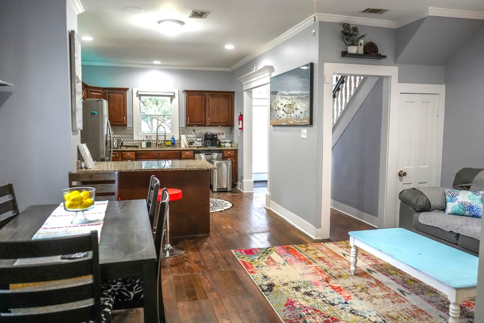 Open kitchen blending stainless steel elegance with original hardwood charm.