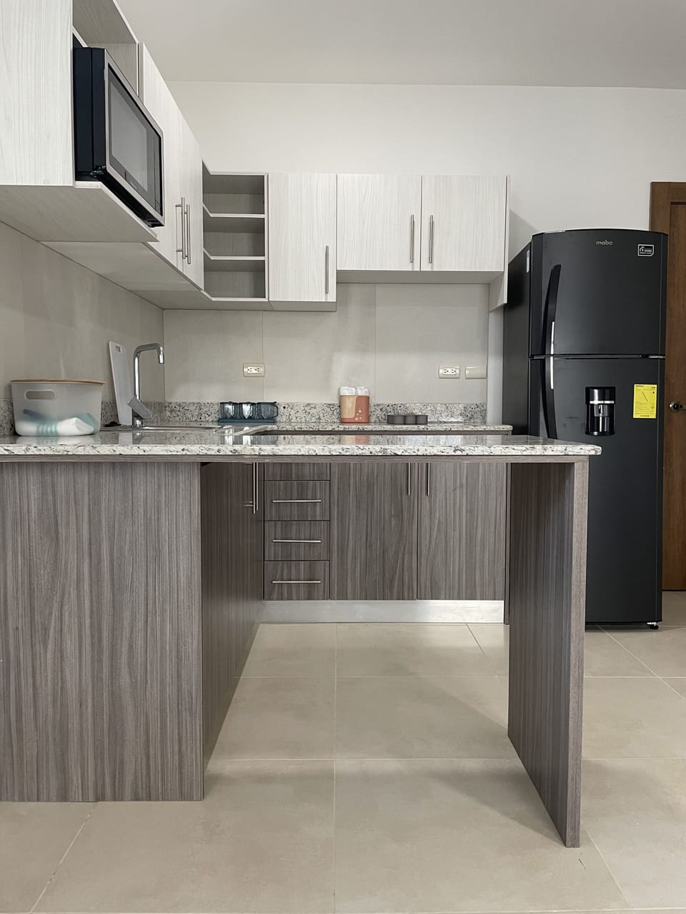 Full-size fridge, microwave, cookware/dishes/utensils