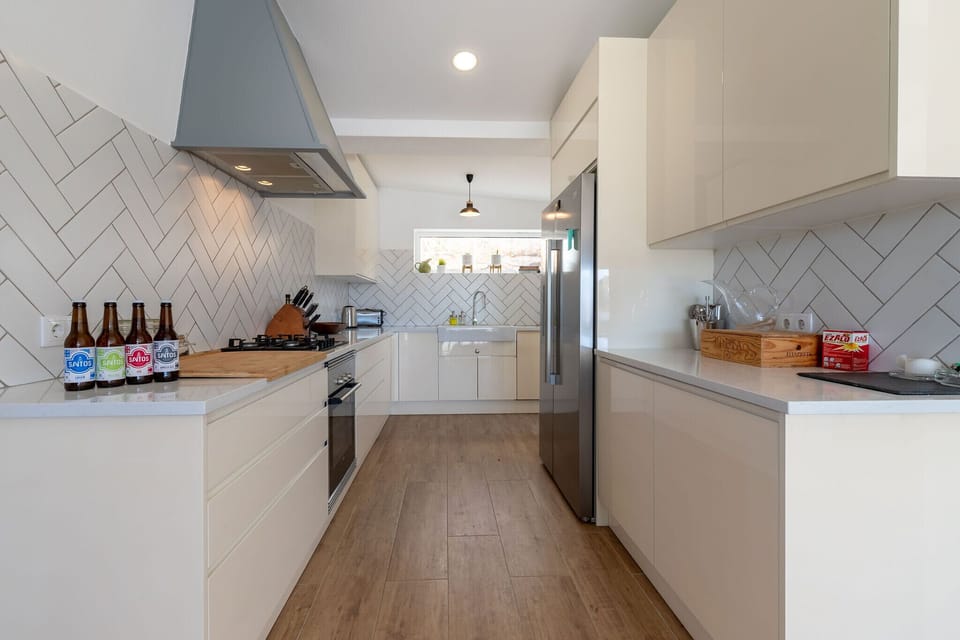 A lovely, large family kitchen with quality appliances and an American fridge.