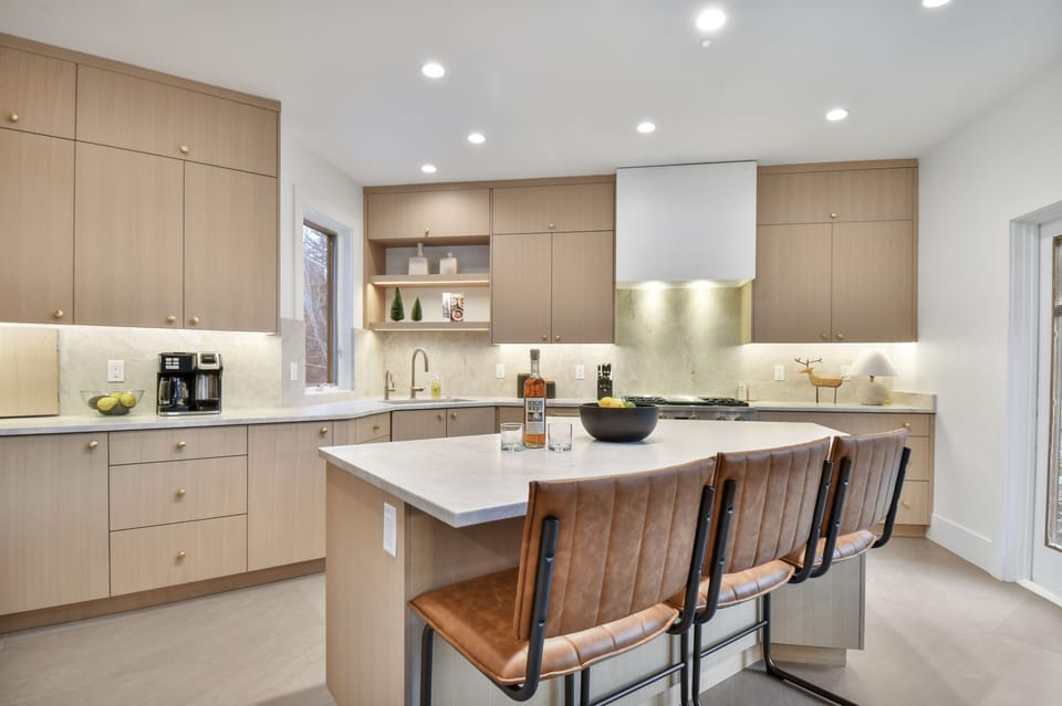 Modern kitchen with beautiful countertops, premium appliances, and chic bar seating.