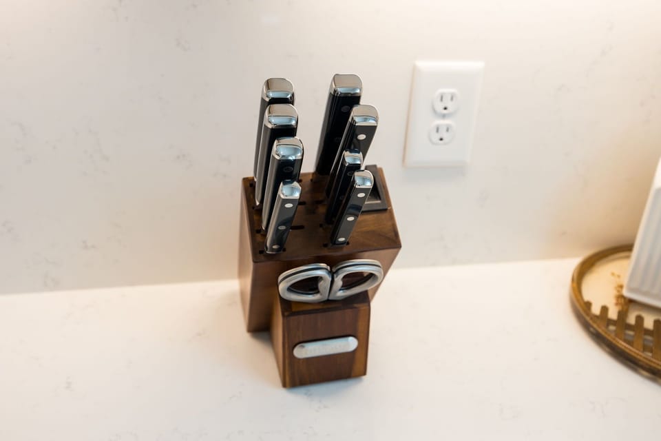 (1st Floor) Fully-equipped kitchen with stainless steel appliances, basic cooking essentials, and kitchen island seating.