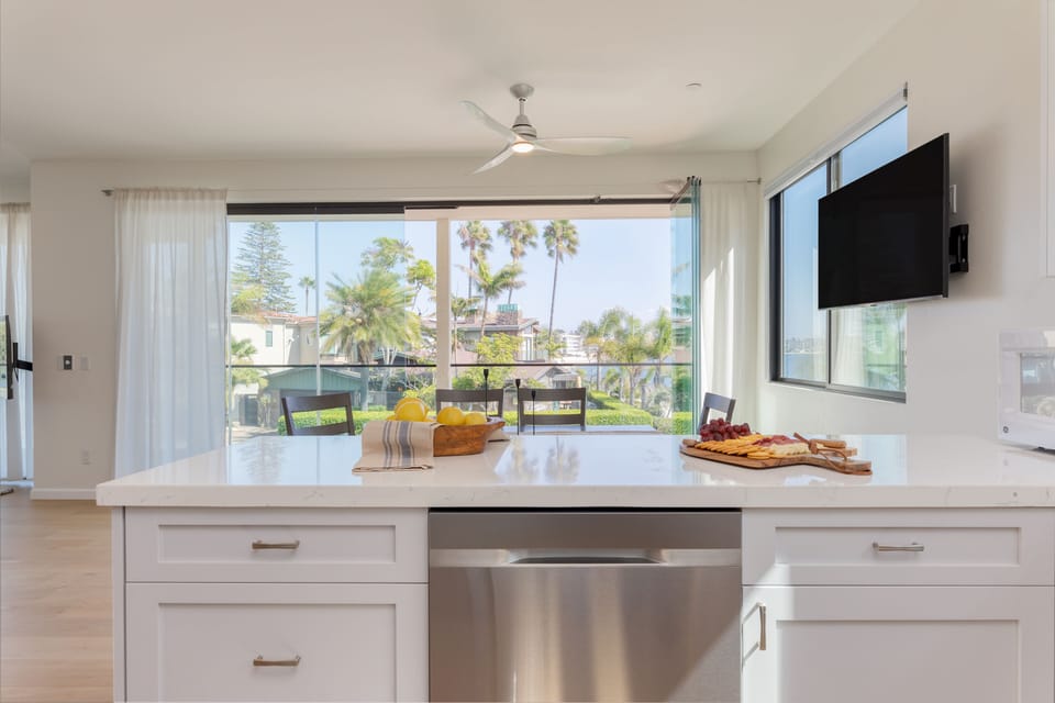 Fully equipped kitchen looks toward the large windows.