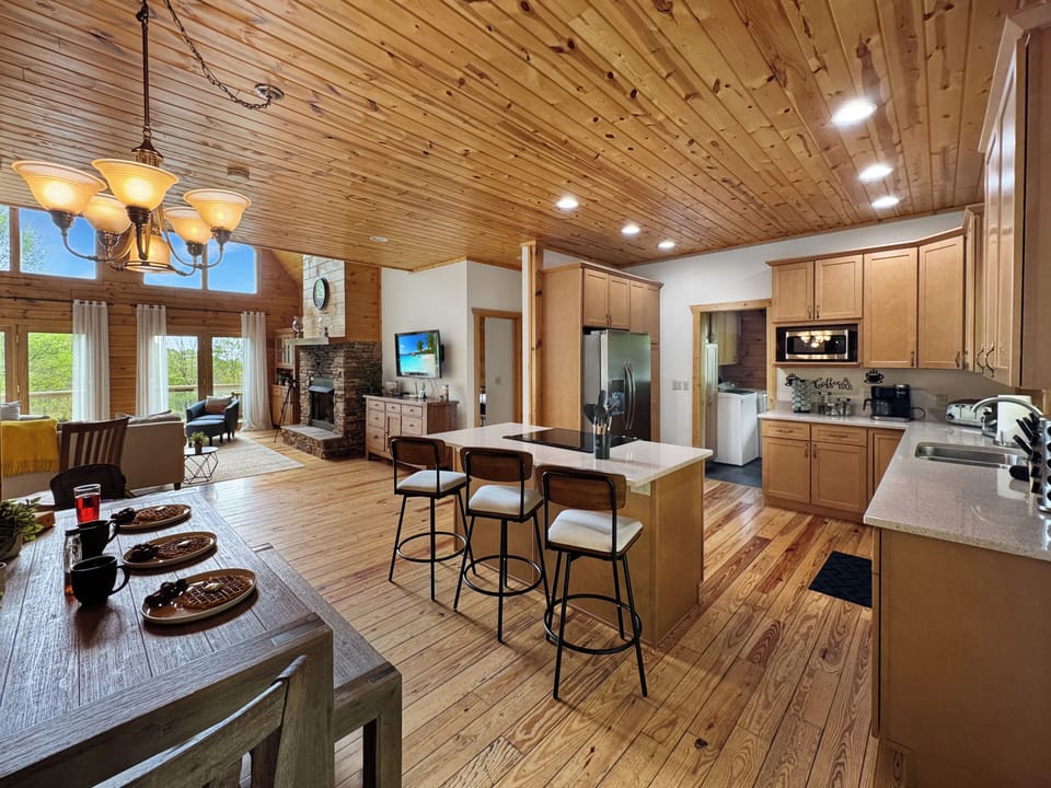 Cook, gather, and enjoy in this spacious kitchen featuring a large island with bar seating. Perfect for group meals or casual snacks, it’s fully equipped and designed for connection—whether you're cooking or just keeping the chef company.
