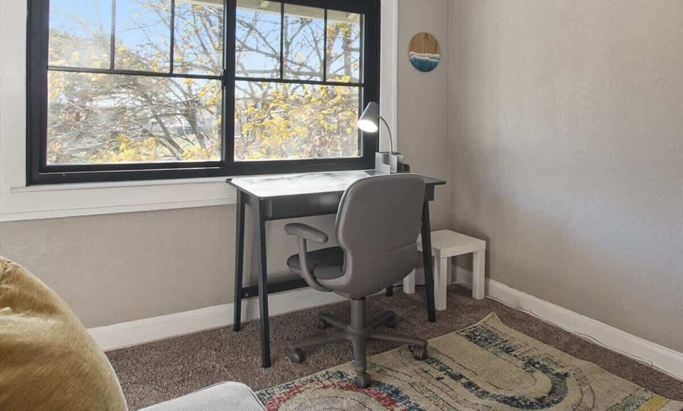 Home office overlooking backyard oak tree canopy. Extra Google Fibre WiFi point located upstairs for fast, reliable internet connection.
