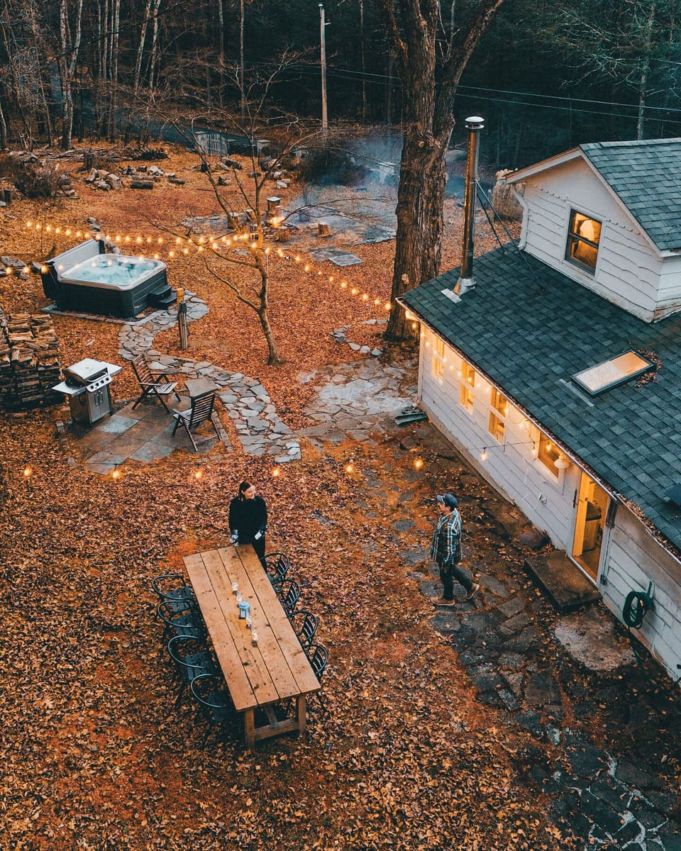 Backyards are made for playing, and that's just what you'll do! Enjoy the stone patio that borders the entire cabin and the wonderful grass areas that surround it. The backyard has everything and more. (@dirtandglass)