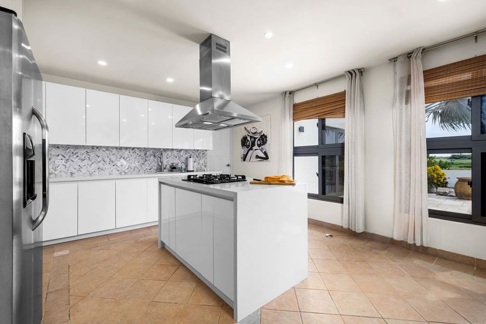 Your modern gourmet kitchen awaits with sleek countertops, professional appliances, and an island perfect for preparing meals while enjoying scenic views through large windows.