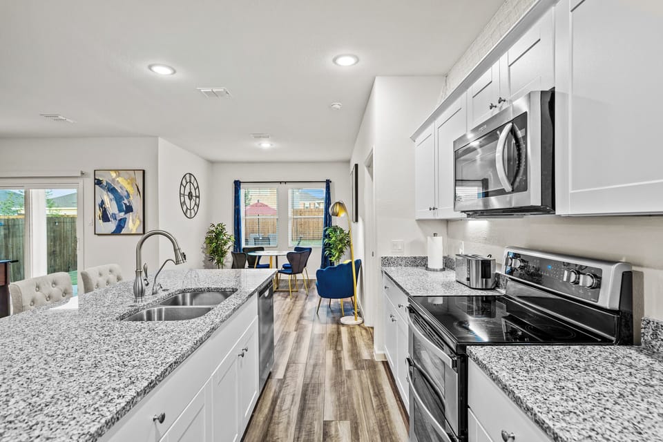 Open kitchen and living area creates an inviting space for cooking, dining and relaxing together. A practical setup for construction crews, corporate travelers, relocating families and insurance housing guests staying longer in Lavon.