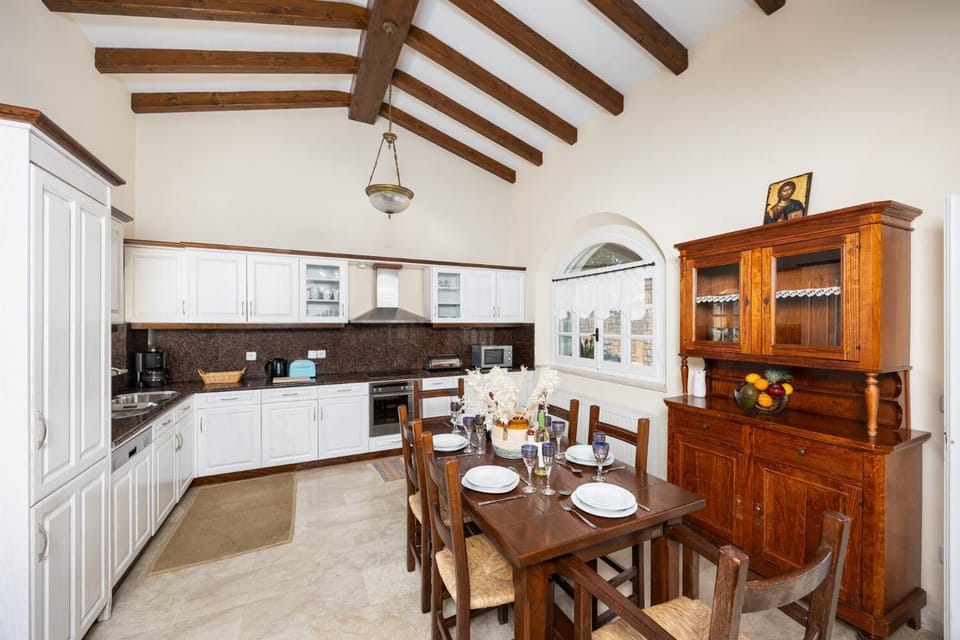 Open-plan living room with sofas, dining area, kitchen, ornamental fireplace, WiFi internet, satellite TV, and sea views