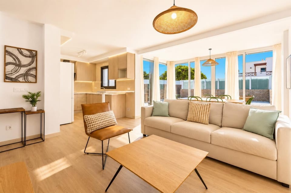 Open-plan living room with sofas, dining area, kitchen, WiFi internet, satellite TV,