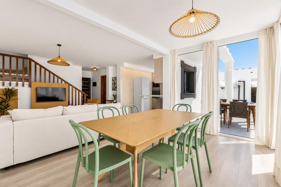 Open-plan living room with sofa, dining area, kitchen, WiFi internet, satellite TV, and sea views