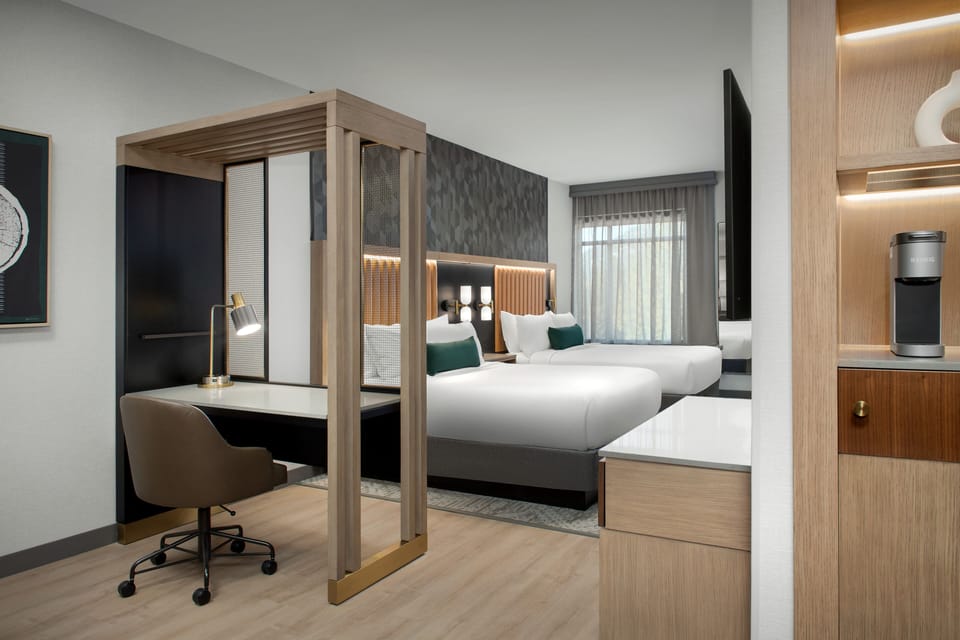 Hypo-allergenic bedding, desk, laptop workspace, blackout drapes