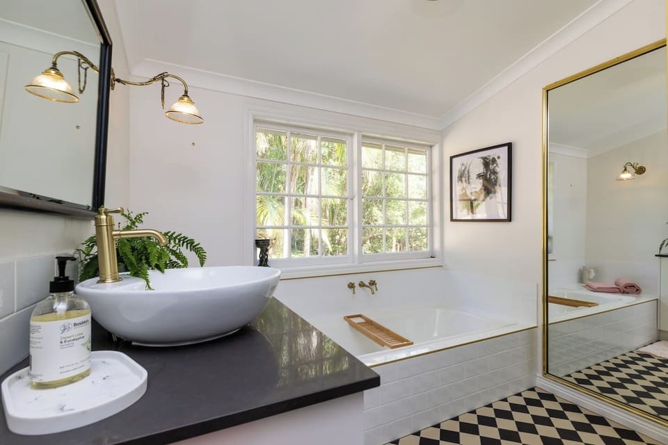 Beautiful enamel bath in Main Bathroom, equipped with instantaneous gas hot water, meaning there is always hot water ....no matter what number you were in the Shower/Bath list...  The bath even has beautiful forest views… Relax and Enjoy 