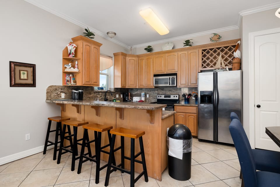 Gather around the kitchen island for easy snacks and meals shared together during your stay