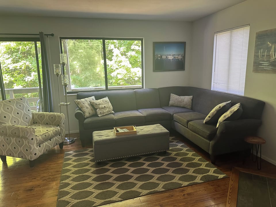 Plenty of seating to relax in the main level living room with fireplace & TV 