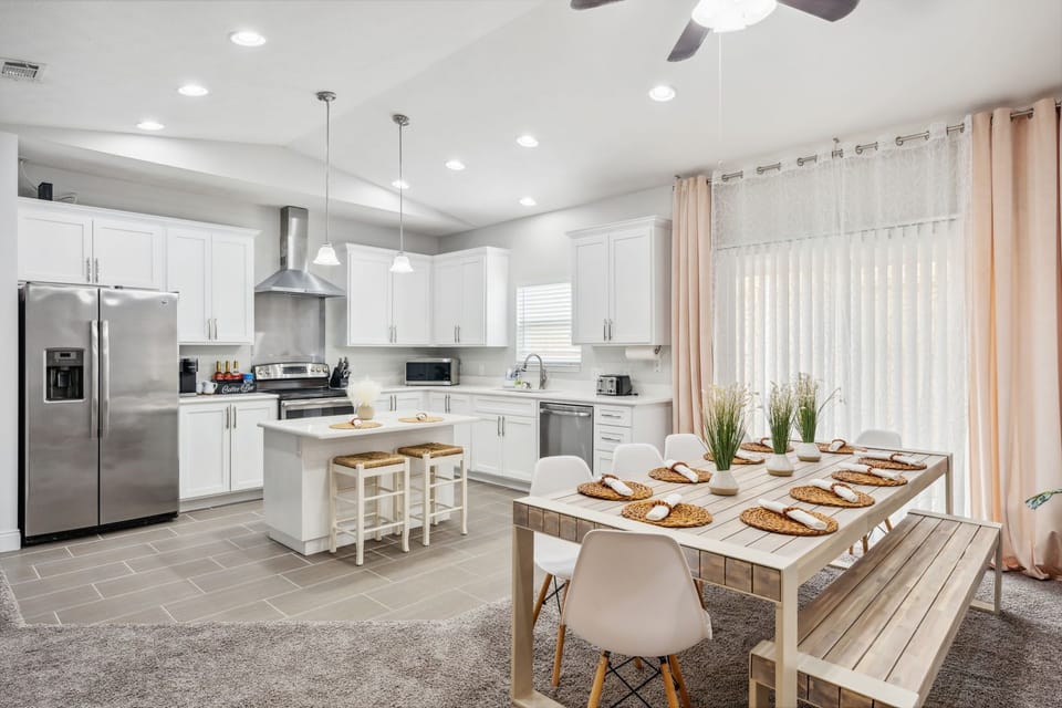 This welcoming dining table can fit 10 people plus 2 on the bar stools.