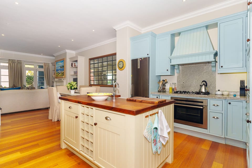 kitchen with gas hob, oven, large fridge and microwave