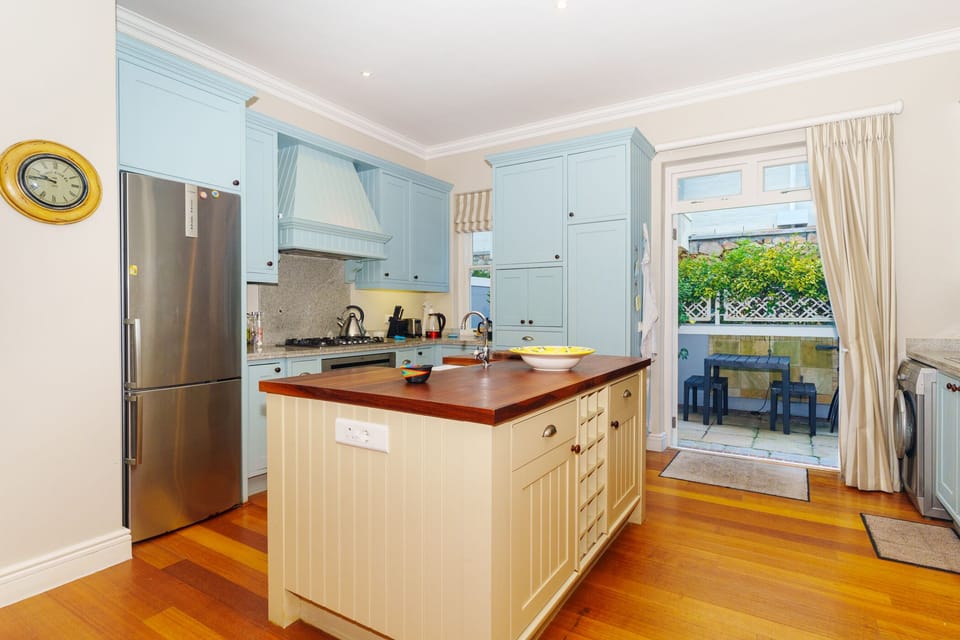 kitchen with gas hob, oven, large fridge and microwave