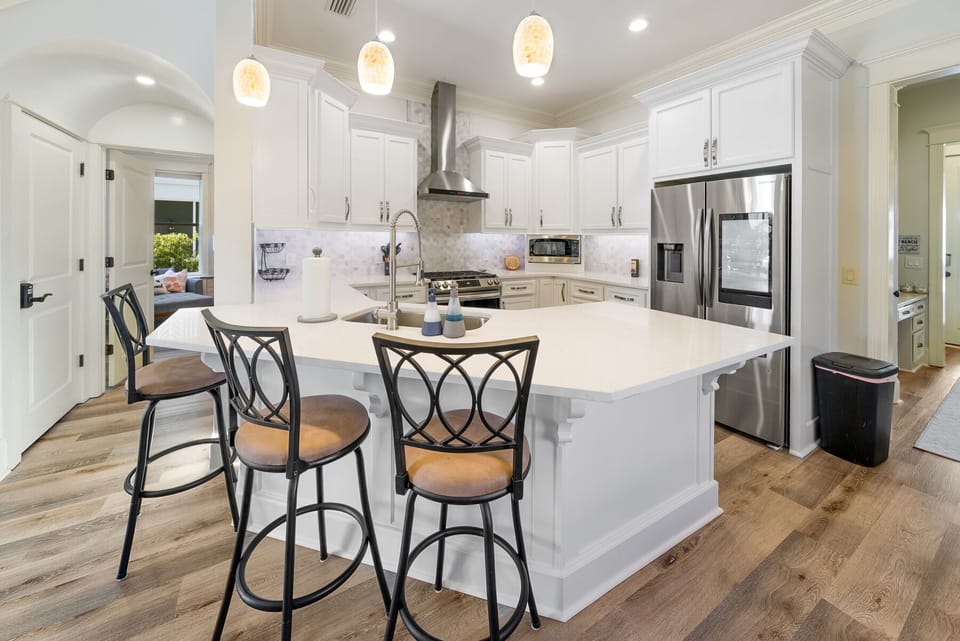Your bright, modern kitchen invites culinary adventures with gleaming countertops, premium appliances, and a welcoming island perfect for morning coffee or evening conversations.