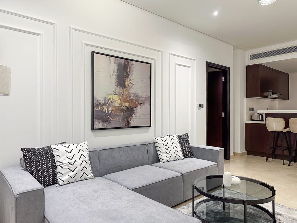 Deluxe Apartment | Living area | 55-inch Smart TV with cable channels
