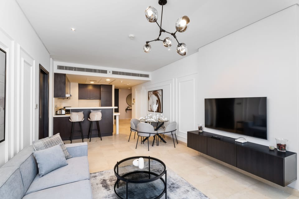 Deluxe Apartment | Living area | 55-inch Smart TV with cable channels
