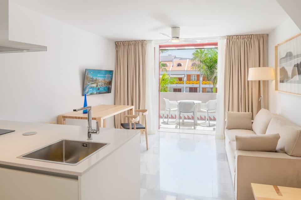 Superior Apartment, 1 Bedroom | Living area | 32-inch flat-screen TV with cable channels