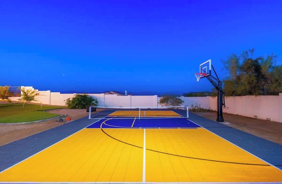 Challenge your friends to a game on your own private multi-sport court with basketball and pickleball—perfect for friendly competition or family fun under clear desert skies.