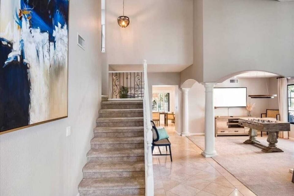 Expansive open-concept living unfolds before you, blending elegant architectural details with airy, sunlit spaces. This seamless layout connects dining to kitchen to living areas—your perfect home base for gathering and relaxing.
