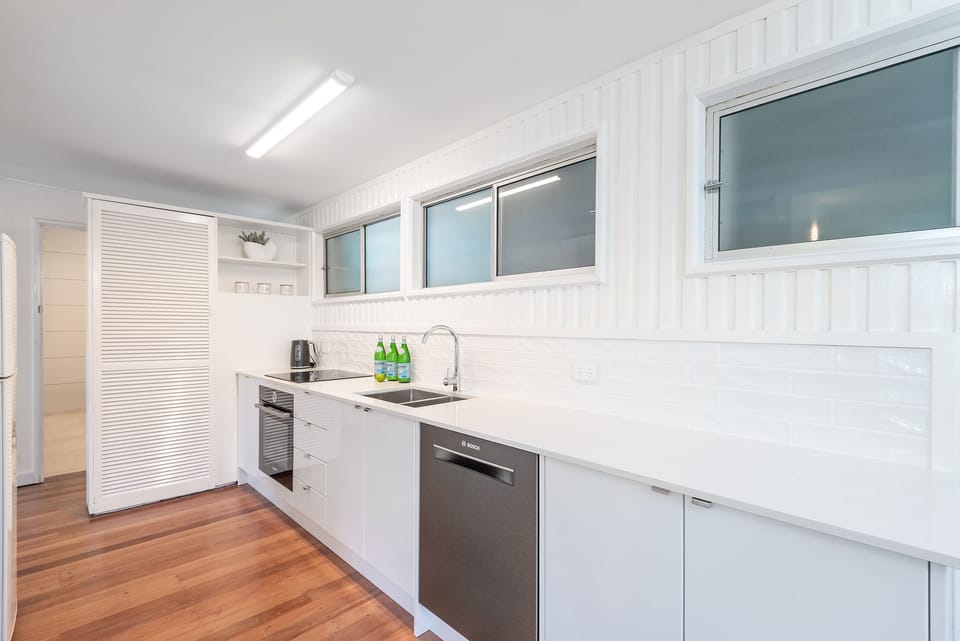 Kitchen has cooktop, oven, microwave, dishwasher, air fryer and Nespresso setup.
