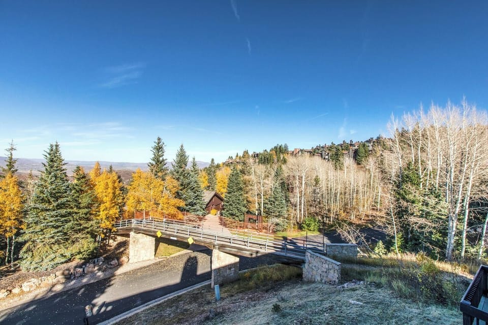 Gorgeous golden foliage surrounds the deck during the fall months - the bridge is your ski path access to Deer Valley ski runs.
