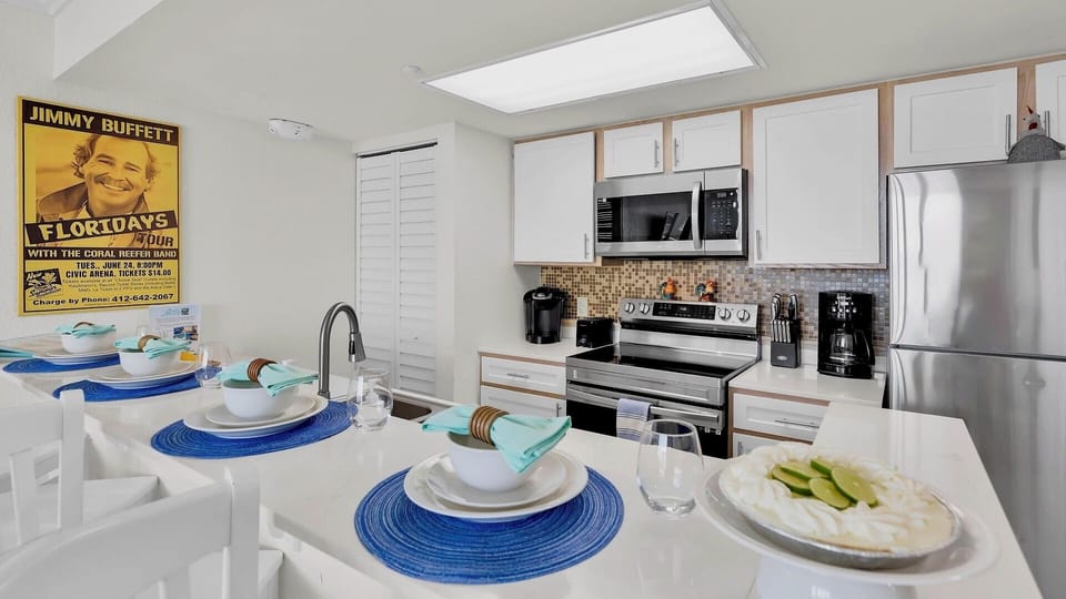Your fully equipped kitchen invites you to prepare fresh meals while soaking up the bright, beachy vibe. Stainless appliances, ample counter space, and coastal charm set the scene for delicious vacation moments.
