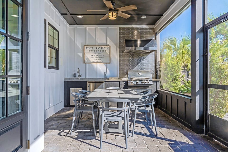 Private backyard oasis with heated pool, hot tub, lounge chairs, hammocks, outdoor dining table, and a screened in outdoor kitchen, dining, and lounge area!