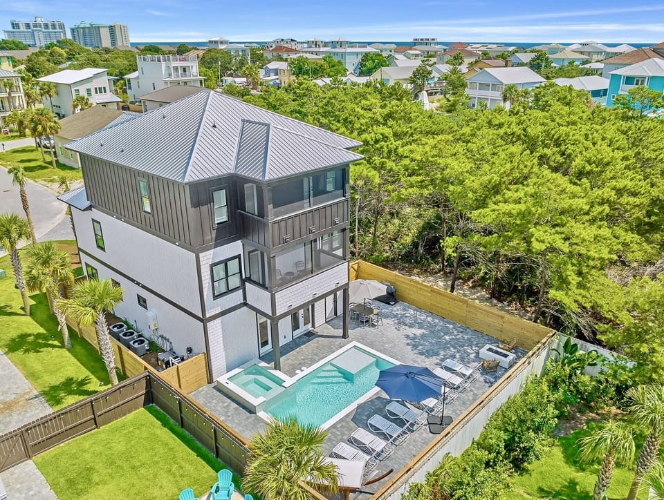 Sandbar - Sleeps 26! Private backyard oasis with heated pool, hot tub, lounge chairs, hammock, grill, outdoor dining table, and a fire pit. Private gated beach access near the house!