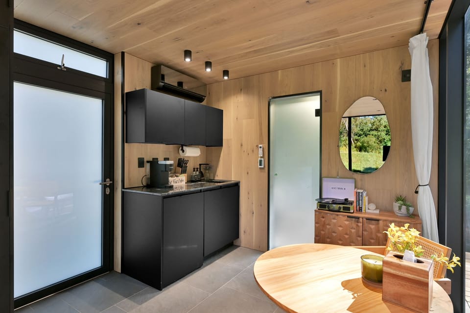 Kitchenette with coffee bar, electric stove top, microwave, utensils, spices, and more