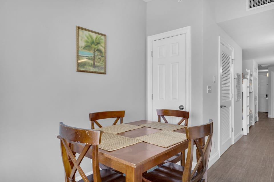 Dining Area - Gather in this stylish dining area with seating for four, perfect for savoring home-cooked meals while soaking in the stunning beach views! Includes 2 bar stools at the kitchen bar for extra seating.