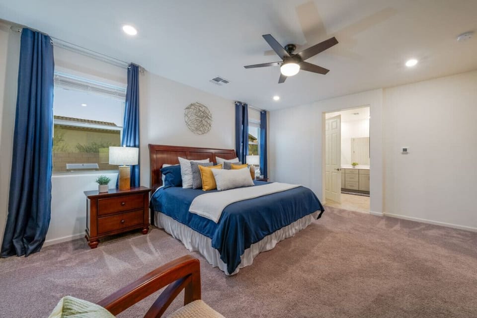 Primary suite`s comfortable king-size bed with plenty of cozy pillows