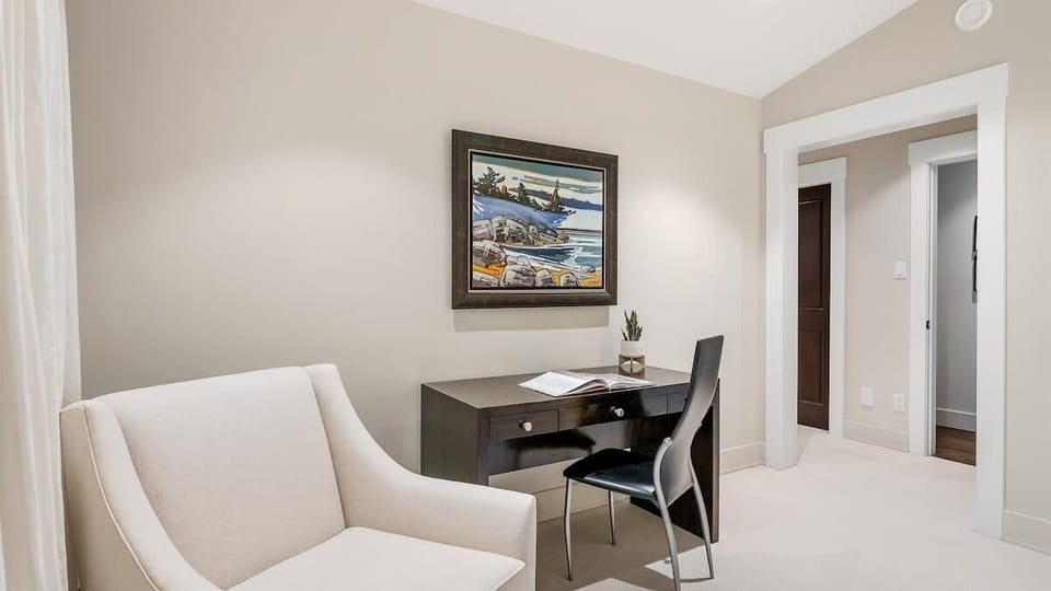 - Quiet workspace with desk and armchair Whistler home  
- Ideal remote work setup with forest inspiration view  
- Relaxed alpine office for focus and creativity  