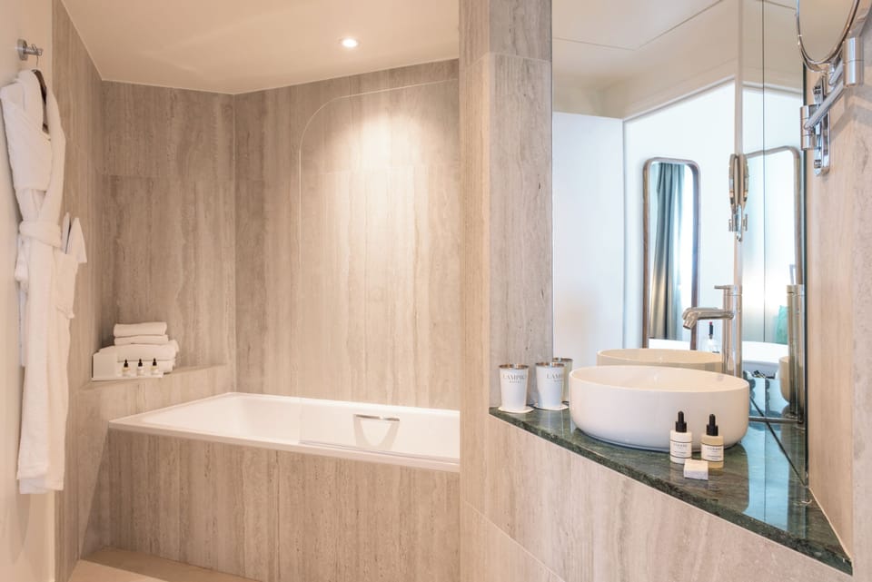 Deluxe Double Room | Bathroom | Bathtub, deep soaking tub, hair dryer, bathrobes