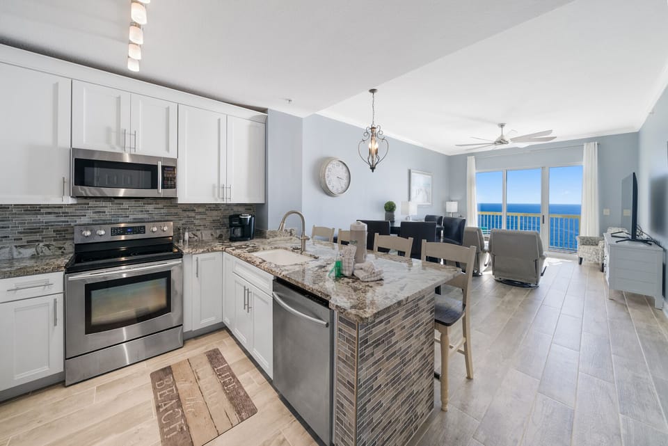 Your stunning oceanfront kitchen opens to breathtaking sea views, where cooking becomes a joy with granite counters and stainless appliances.