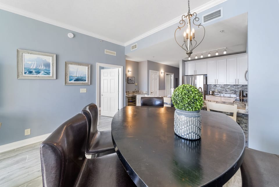 Gather around this elegant dining table where memorable meals await, perfectly positioned between the stylish kitchen and cozy living space.