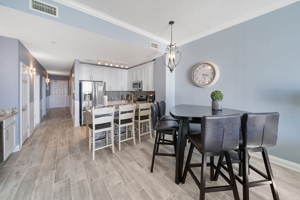 Your modern kitchen flows seamlessly into a cozy dining space where you'll enjoy meals together around the elegant round table.