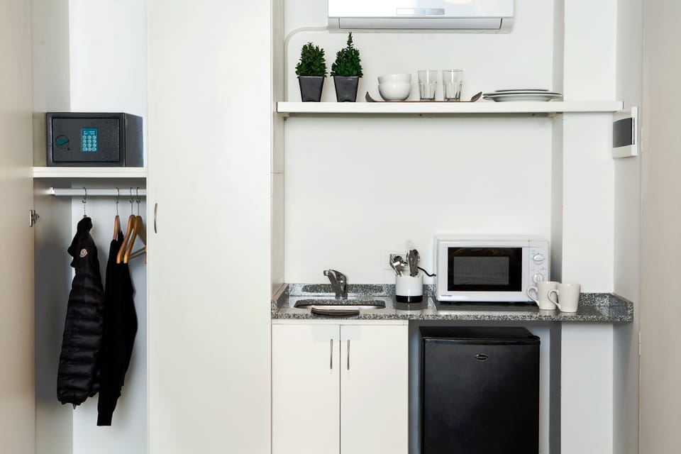 Mini-fridge, microwave, electric kettle, cookware/dishes/utensils