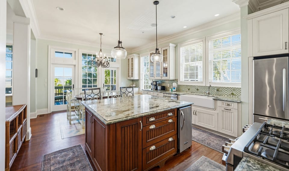 Kitchen with Island Bar,  Dining Area and Access to Back Screened Porch