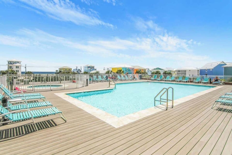 Elevated pool with expansive sun deck and kiddy pool offering Gulf views. 