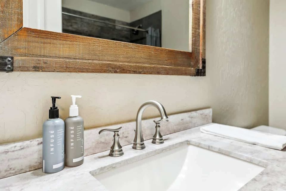 A full bathroom with practical storage and fresh guest supplies helps keep busy mornings moving smoothly. Professionally prepared before every arrival, with 24/7 local support if you need assistance.