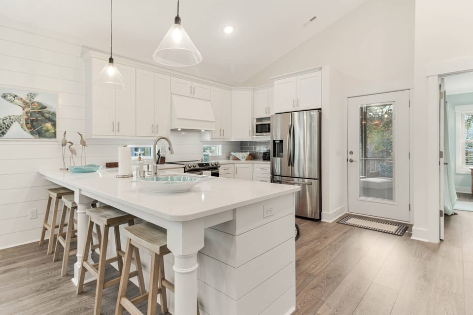 Though the door to the right of the refrigerator is the entrance to the Screened Back Porch (Upper Level).