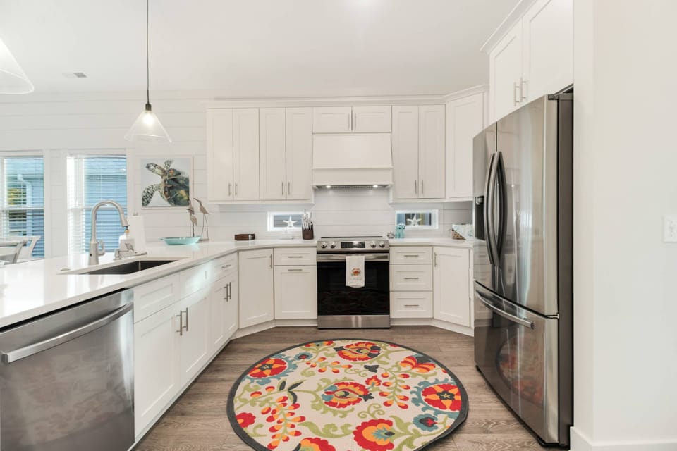 Deep undermount  stainless sink; Lots of cabinets full of gorgeous coastal inspired dishes & silverware.